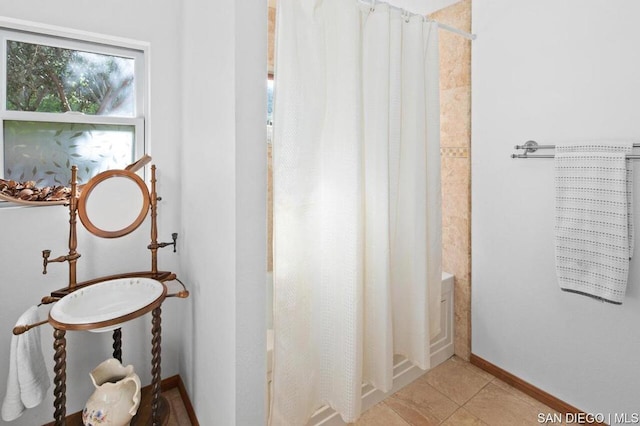 bathroom featuring shower / tub combo and tile patterned flooring