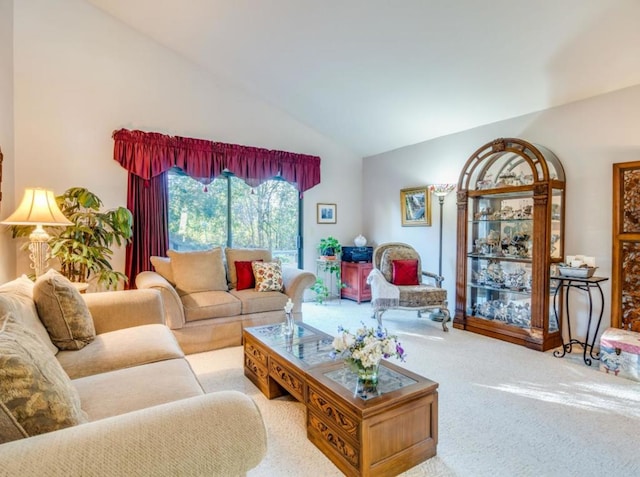 living room featuring lofted ceiling and light carpet