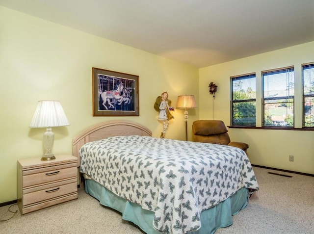 bedroom featuring light colored carpet