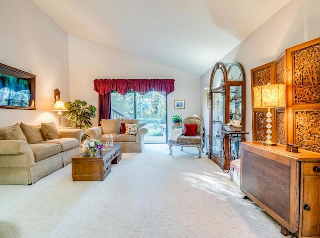 carpeted living room with high vaulted ceiling