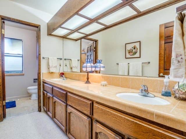 bathroom with vanity, tile patterned floors, and toilet