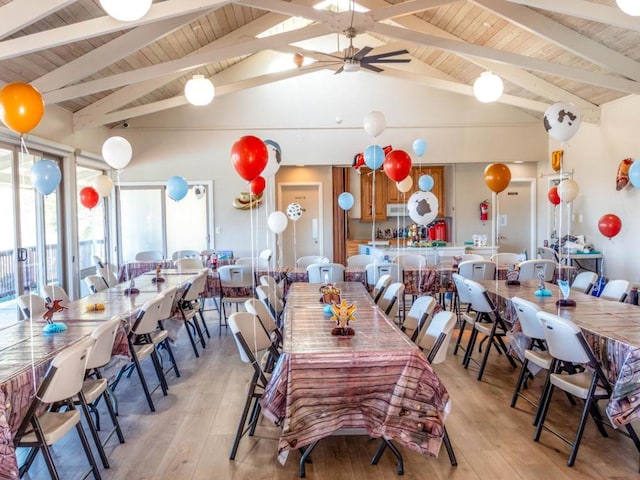 dining space featuring vaulted ceiling with beams, light hardwood / wood-style flooring, and wooden ceiling