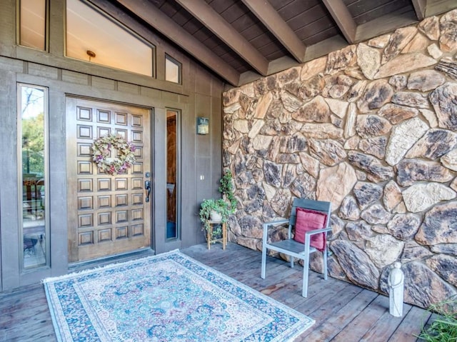 view of exterior entry with a wooden deck