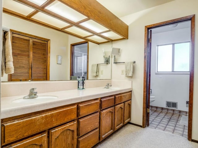 bathroom with vanity, tile patterned floors, and toilet