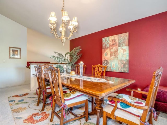 carpeted dining room with a chandelier