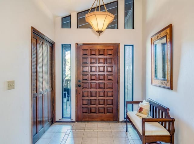 tiled entrance foyer featuring a healthy amount of sunlight