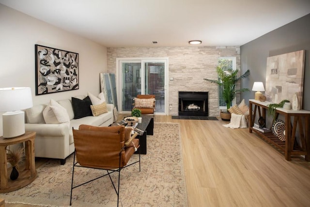 living room featuring hardwood / wood-style floors and a tiled fireplace