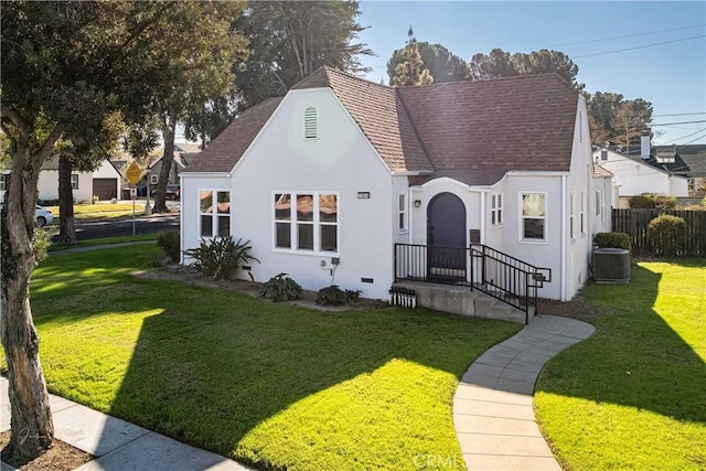 bungalow-style home with central AC and a front lawn