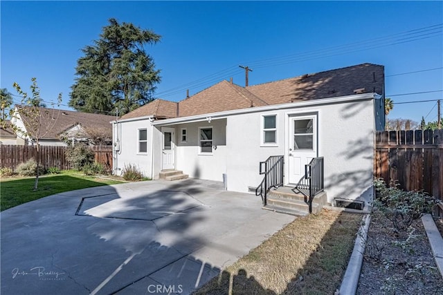 rear view of property featuring a yard