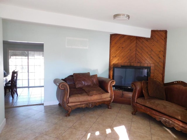 tiled living room with a fireplace and wooden walls