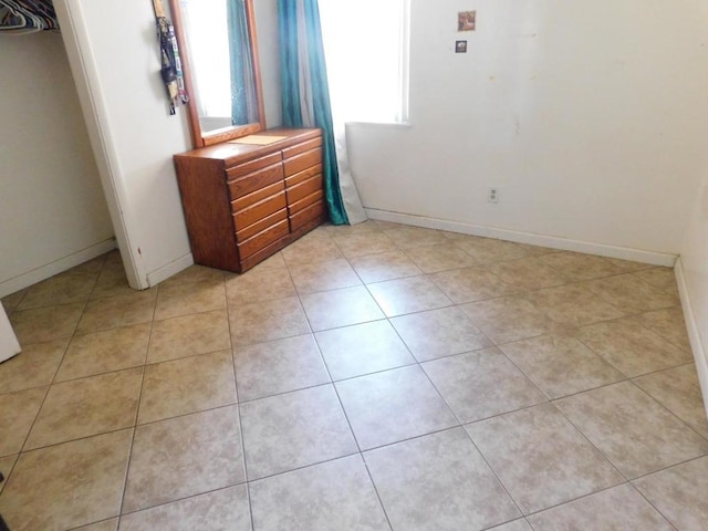 unfurnished bedroom with light tile patterned floors