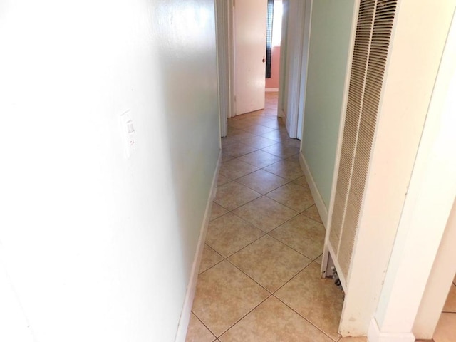 hall with light tile patterned floors