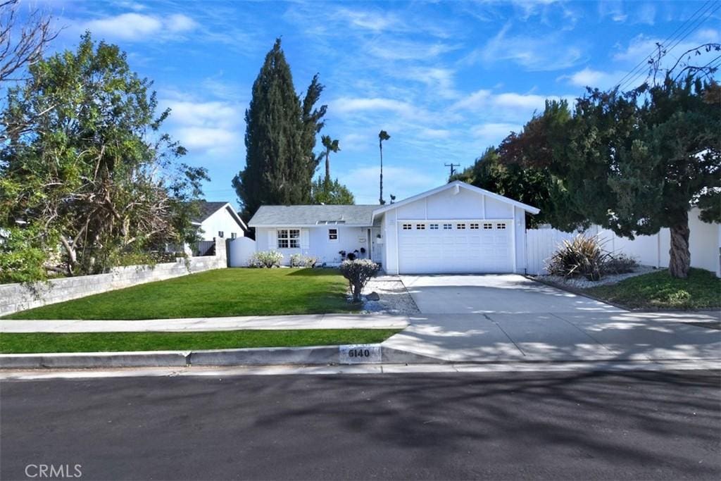 ranch-style house with a front yard and a garage