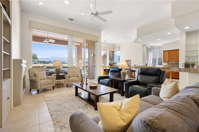 living room with ceiling fan and light tile patterned flooring