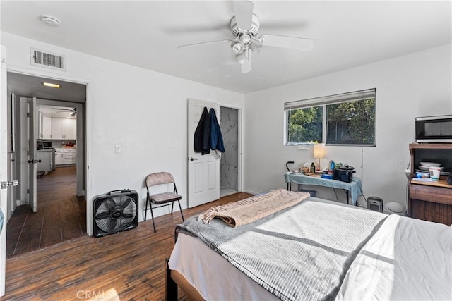 bedroom with ceiling fan and dark hardwood / wood-style flooring