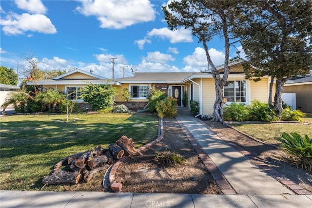 single story home featuring a front lawn