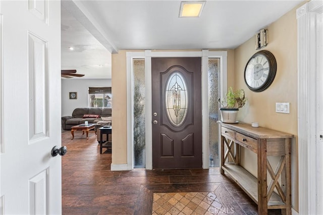 entrance foyer with ceiling fan and dark wood-type flooring