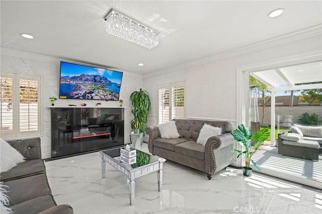 living room with an inviting chandelier and ornamental molding