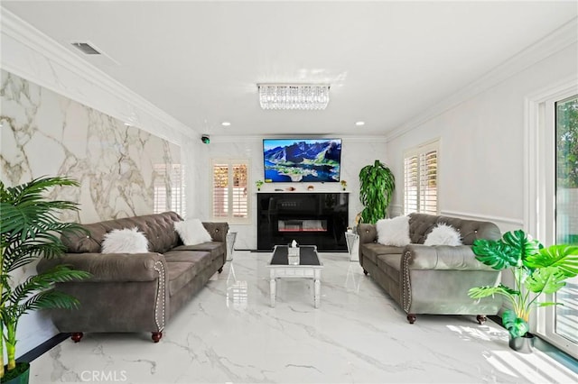 living room featuring crown molding and a chandelier