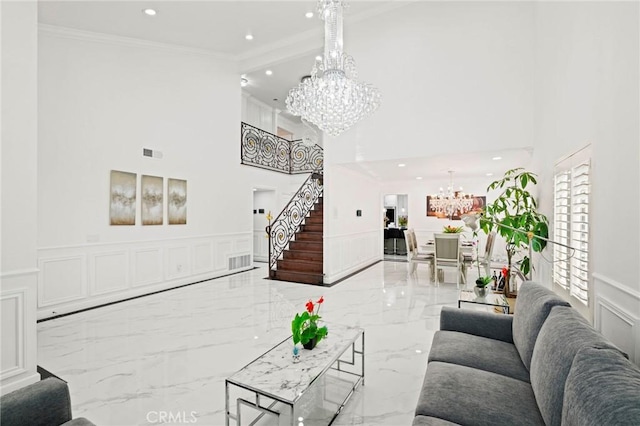 living room with crown molding and a notable chandelier