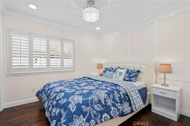 bedroom with dark wood-type flooring, ornamental molding, and a notable chandelier