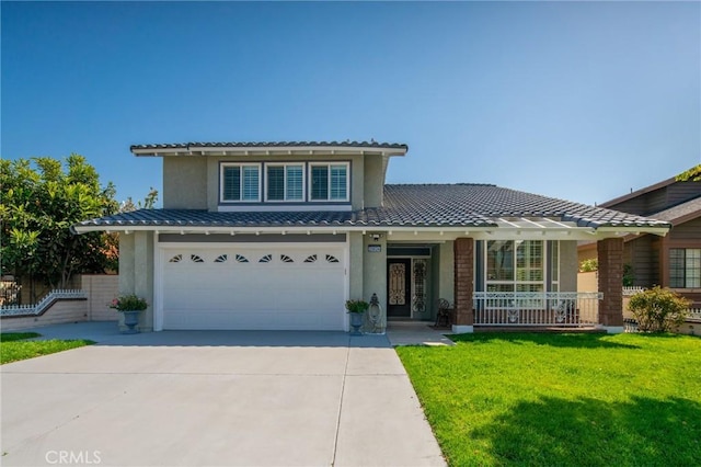 view of front of house featuring covered porch, a garage, and a front lawn