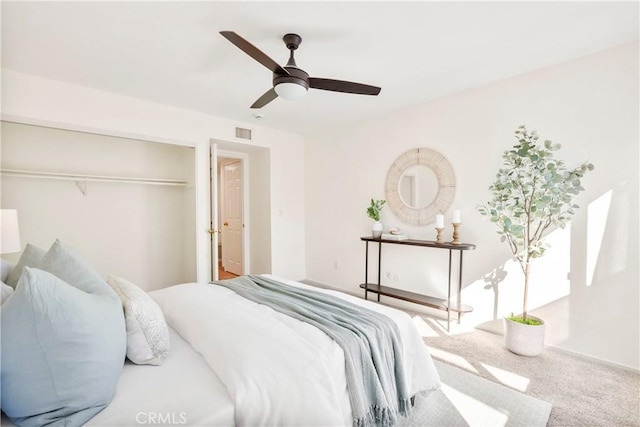 bedroom featuring carpet, ceiling fan, and a closet