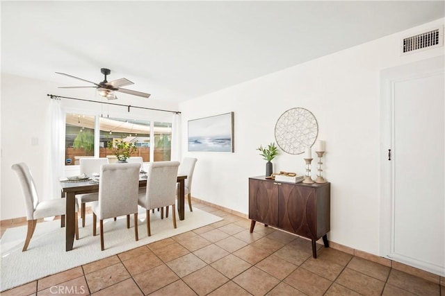 tiled dining area with ceiling fan