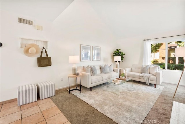 tiled living room with high vaulted ceiling