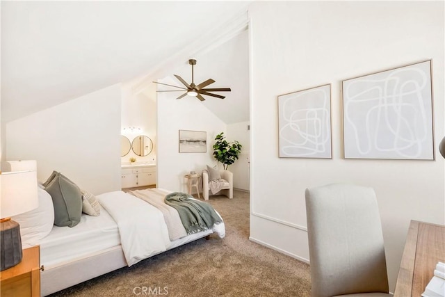 bedroom with ensuite bath, carpet flooring, and vaulted ceiling