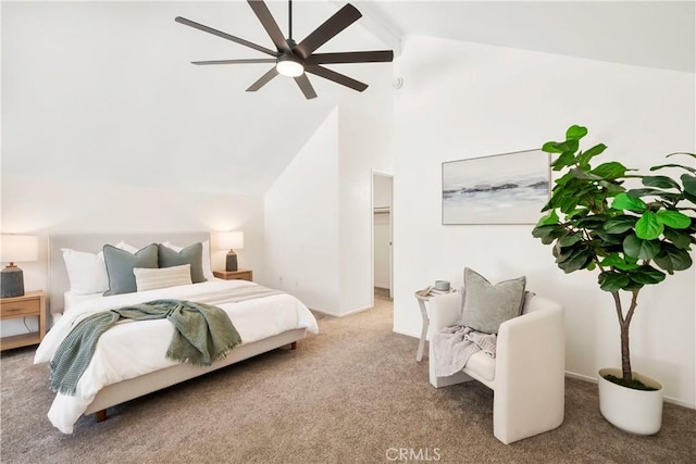 bedroom with vaulted ceiling, a spacious closet, ceiling fan, and carpet flooring