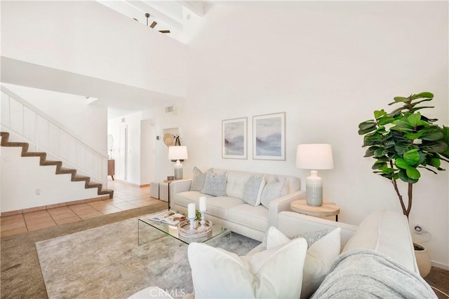 living room featuring light tile patterned floors and ceiling fan