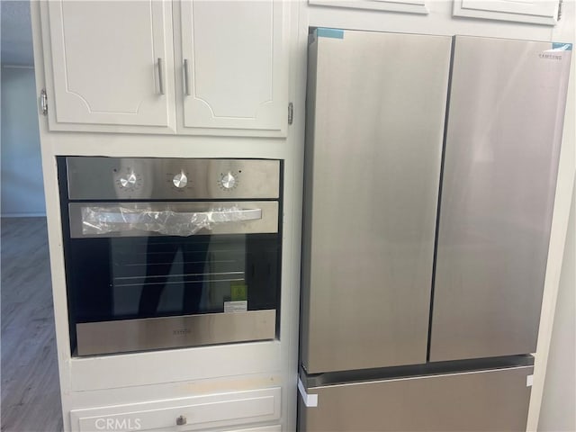 room details featuring white cabinetry and appliances with stainless steel finishes