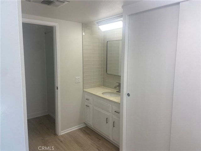 bathroom featuring wood-type flooring and vanity