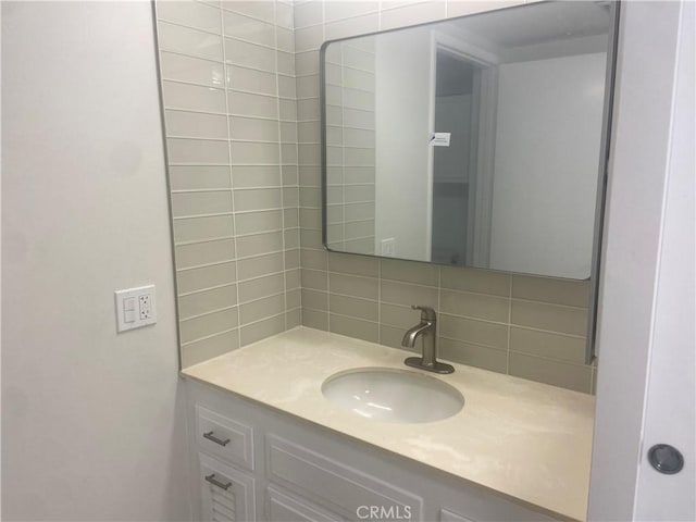 bathroom featuring vanity and decorative backsplash