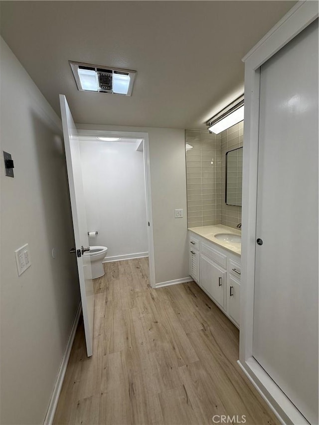 bathroom featuring vanity, toilet, and wood-type flooring