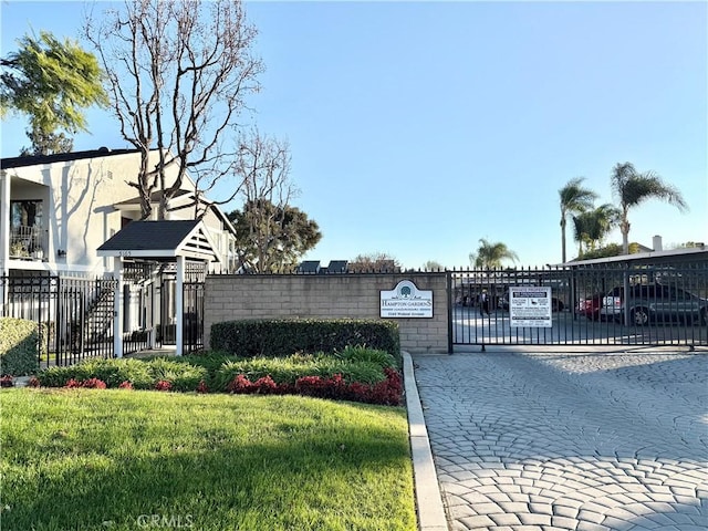 view of gate featuring a yard