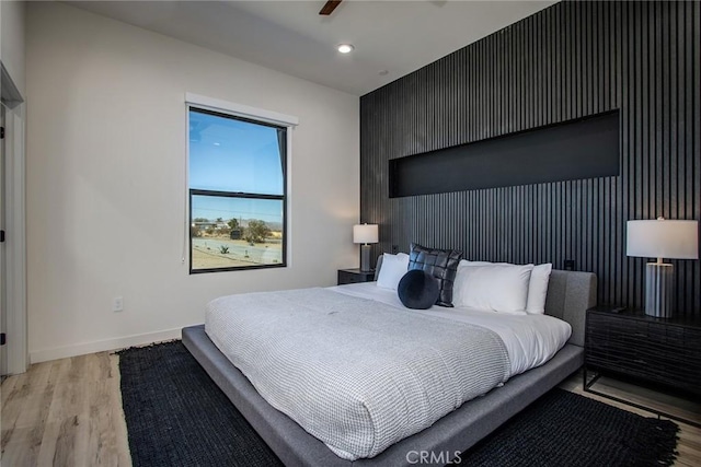 bedroom with ceiling fan and light wood-type flooring