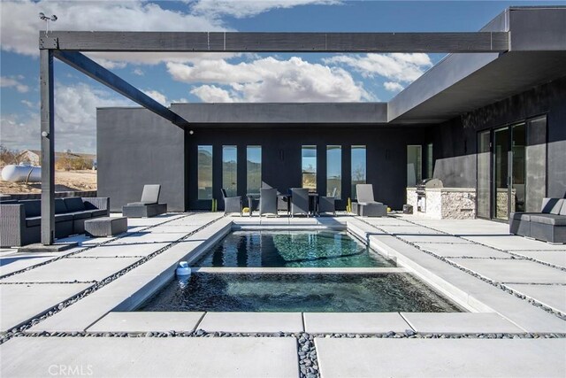 view of swimming pool featuring exterior kitchen, outdoor lounge area, a patio, and an in ground hot tub