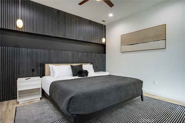 bedroom with hardwood / wood-style flooring and ceiling fan