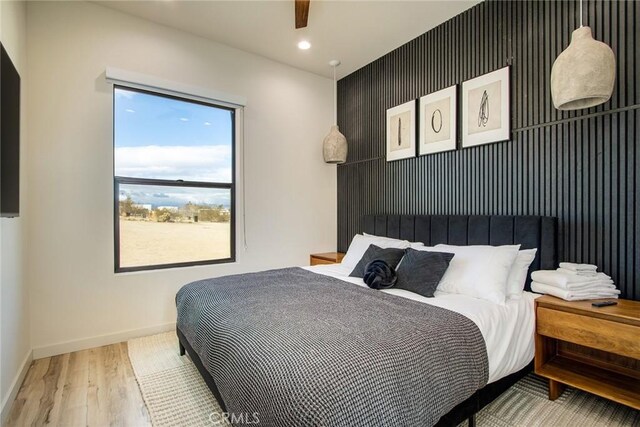 bedroom featuring ceiling fan and wood-type flooring