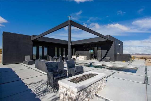 view of patio / terrace featuring an outdoor fire pit