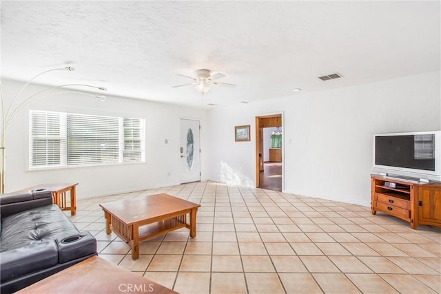 tiled living room with ceiling fan