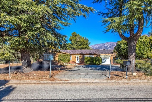 single story home featuring a mountain view and a garage