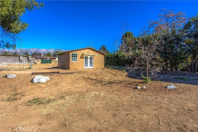 view of yard with a mountain view and french doors