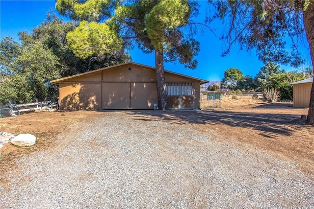 view of side of home featuring an outbuilding