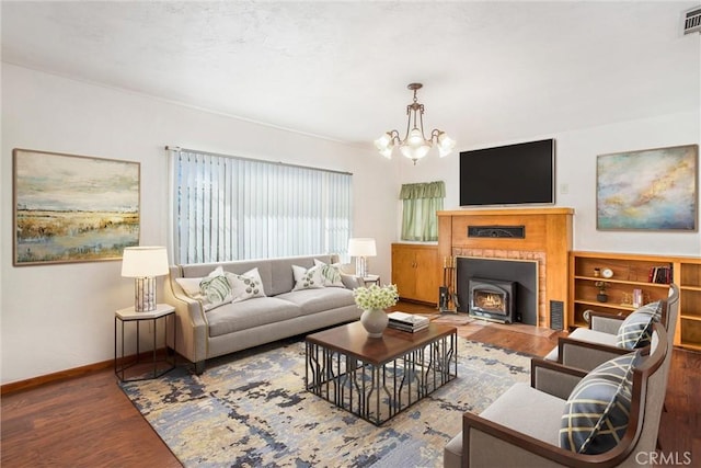 living room with hardwood / wood-style flooring and a notable chandelier