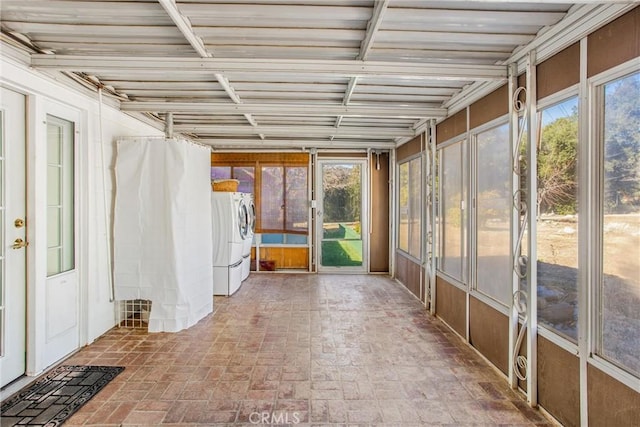 unfurnished sunroom with separate washer and dryer