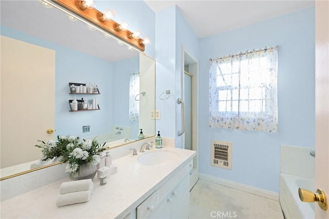 bathroom with vanity, a tub, and heating unit