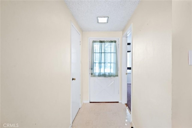 doorway with a textured ceiling